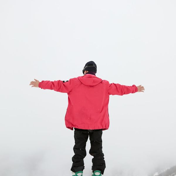 Person feeling energized and stretching arms upwards in nature.